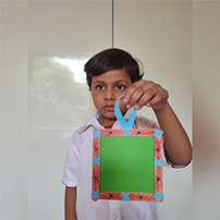 Nursery kids caged their sweet fond memories by making square shaped photo frame.